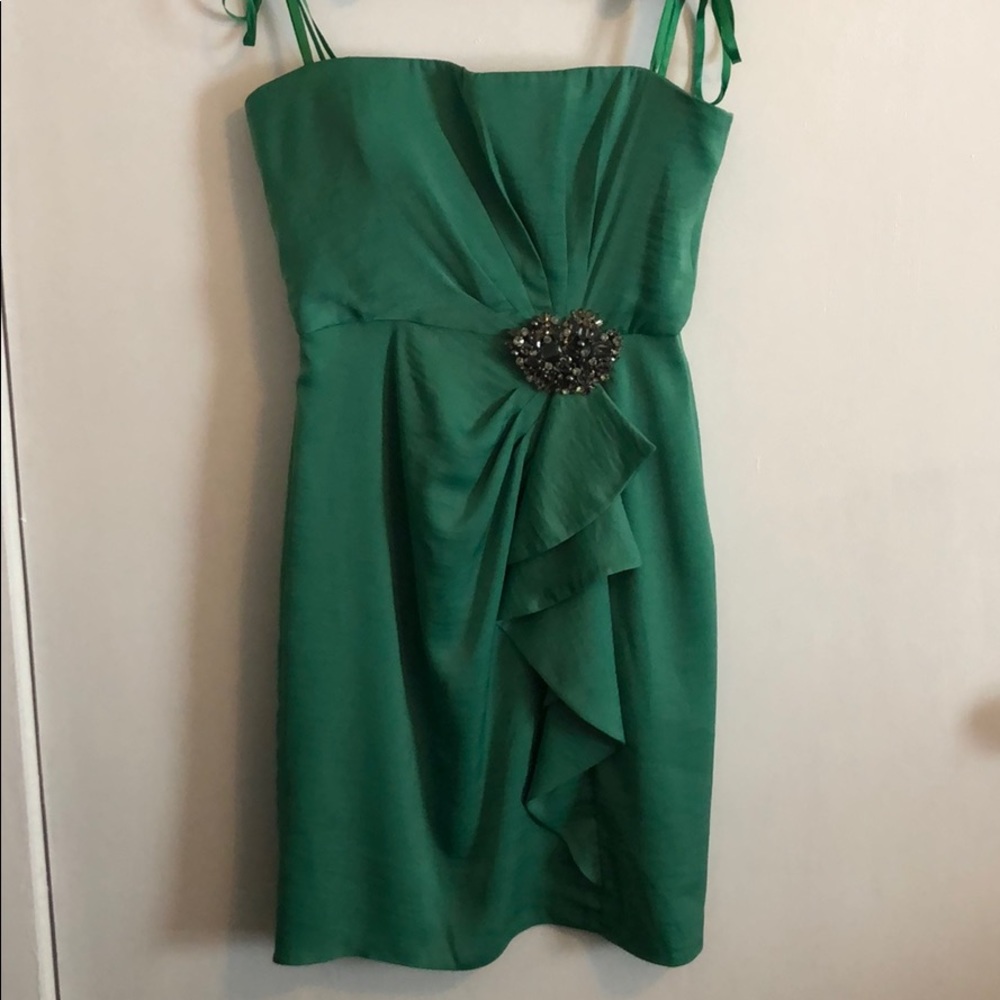 Strapless mini dress with removable broach.